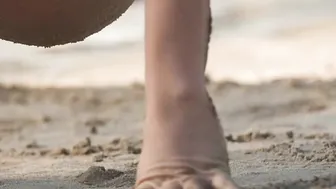 Exotic cutie Natalia playing on a sandy beach