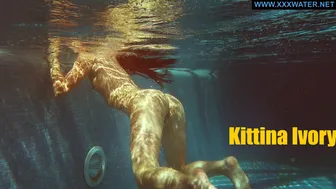 Kittina submerges herself in to the hot pool