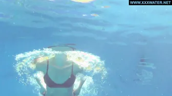 Kittina submerges herself in to the hot pool