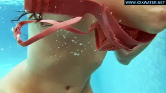 Kittina submerges herself in to the hot pool